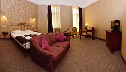 a hotel room with a couch and a bed at Boutique Apart Hotel Adagio in Tbilisi City