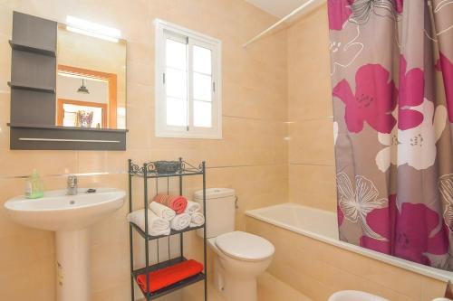 a bathroom with a sink toilet and a shower curtain at Villa privada con increíbles vistas al mar in Torrox Costa