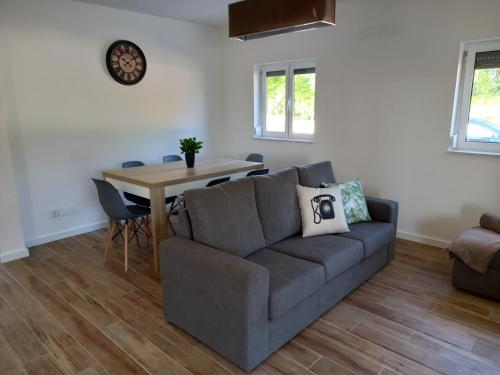 a living room with a couch and a table at Casas da Ladeia - Villa 1 in Alvorge