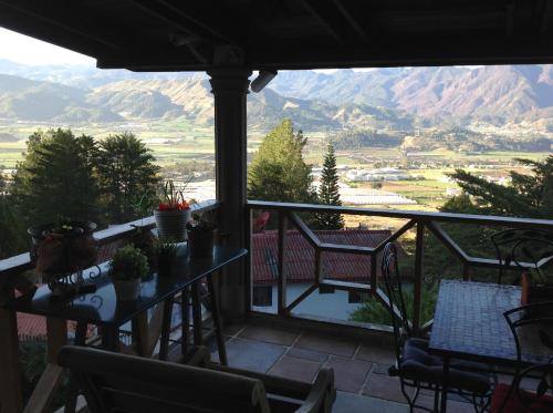a balcony with a table and chairs and mountains at Villa Paloma/ Home/ Office-Remote Office in Constanza