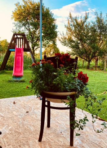 a chair with flowers on it next to a playground at Ubytovanie u Aranky in Čierna nad Tisou