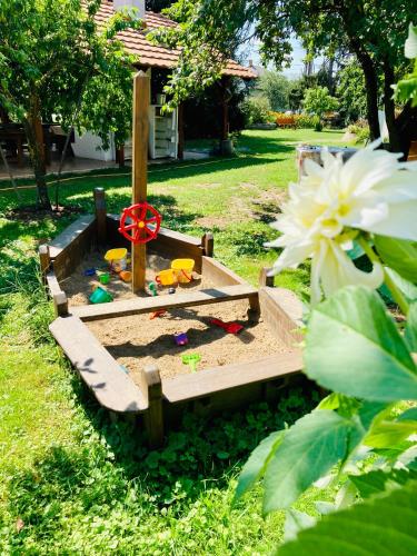 a sandbox in the grass with a toy in it at Ubytovanie u Aranky in Čierna nad Tisou