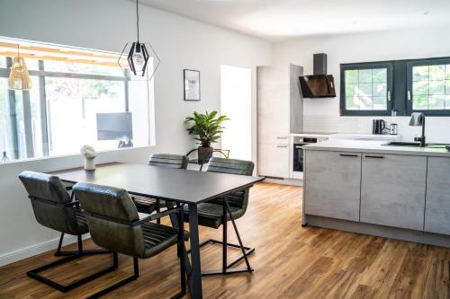 a kitchen and dining room with a table and chairs at hygge Niederrhein in Rees