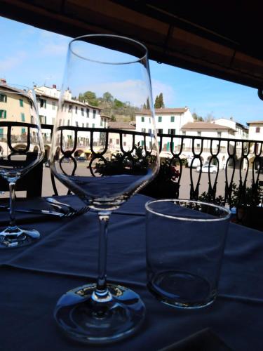 two wine glasses sitting on top of a table at Albergo Giovanni Da Verrazzano in Greve in Chianti
