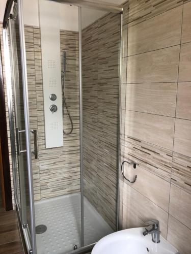 a bathroom with a shower with a toilet and a sink at Villa Cataleya in Praia a Mare