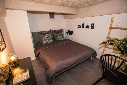 a bedroom with a large bed in a room at UrbanJungle - Your trendy loft in central Budapest in Budapest