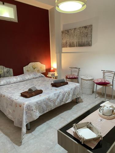 a bedroom with a bed and two tables and chairs at Il vicoletto in Brindisi