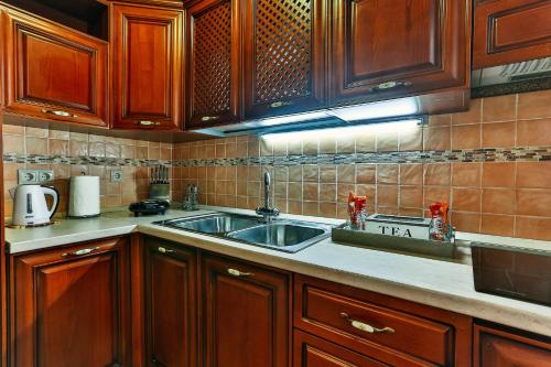 a kitchen with wooden cabinets and a sink at apartman 367 in Kotor