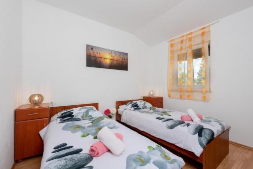 Posteľ alebo postele v izbe v ubytovaní Holiday House Dora