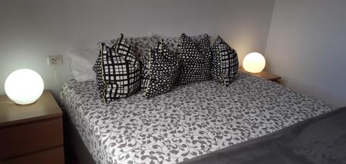 a bedroom with a bed with black and white pillows at Apartamento La Caleta El Hierro Island terrace with incredible views in La Caleta