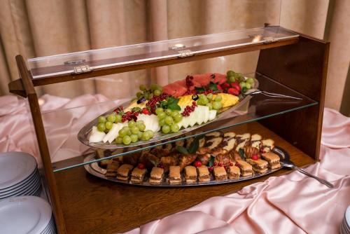 a display case with two trays of different types of food at Hotel Mara in Sinaia
