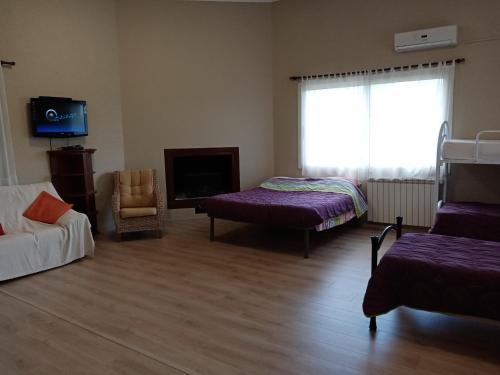 a room with two beds and a couch and a television at AZIENDA AGRICOLA 25 PONTI in Gaeta