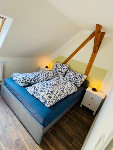 a bed with two pillows on it in a room at HaRe Ferienwohnungen in Langeneß