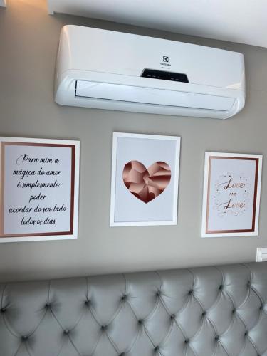 a room with two pictures of a heart on the wall at "Conforto e Bem Estar" Próximo da praia in Balneário Camboriú