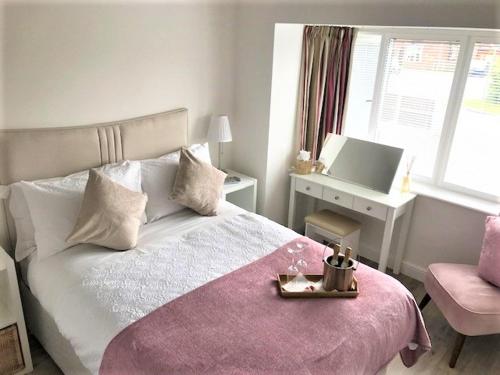 a bedroom with a bed with a tray on it at Oak Tree Annex Keppel Gate B & B in Overseal