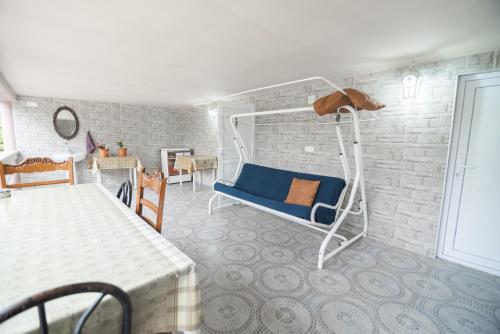 a bedroom with a blue bed in a brick wall at Cozy apartment near Kobuleti with mountain view in K'obulet'i