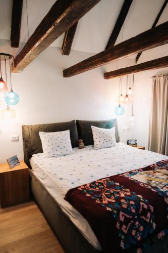 a bedroom with a large bed in a room with beams at OberWood in Porumbacu de Sus
