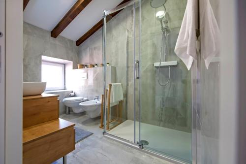 a bathroom with a glass shower and a toilet at The Attic Rovinj in Rovinj