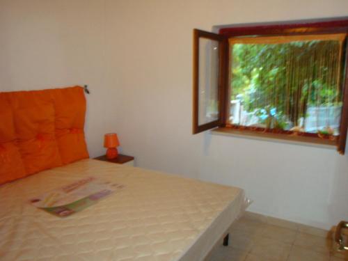 a bedroom with a bed and a window at Sunset Lodge in Paola