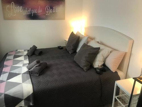 a bedroom with a bed with pillows on it at ViNALUX in Vinaròs