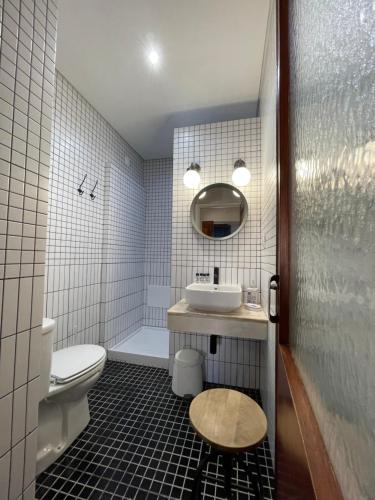 a bathroom with a sink and a toilet and a mirror at Casas da Formosa - Downtown Alegria in Tavira
