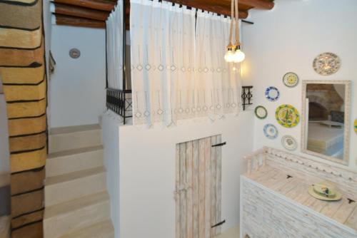 アルハンゲロスにあるRhodes Archangelos Traditional village house in with private yardの暖炉と鏡のある階段付きの部屋