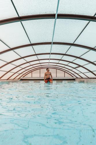 a man standing in a pool of water at Alentejo Marmòris Hotel & Spa in Vila Viçosa