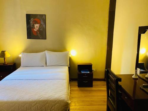 a bedroom with a bed and a lamp at Casa Franciscana in Quito