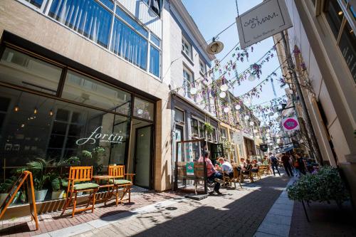 a street with people sitting outside of a store at Deluxe 35m2 City Center Suite with Views - DB6C in Den Bosch