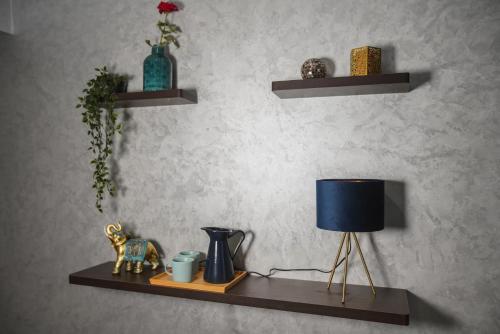a shelf with a lamp and a vase on it at Hotel Tildi Hotel & Spa in Agadir