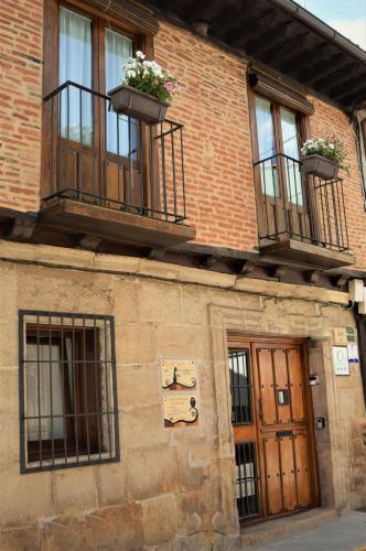 a brick building with two balconies and two windows at Casa Bethona in Jerte