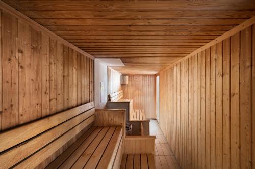 a sauna with wood paneled walls and a wooden ceiling at voco St. David's Cardiff by IHG in Cardiff