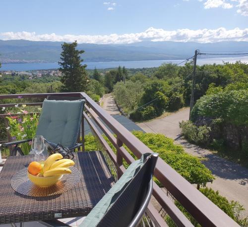 a bowl of bananas on a table on a balcony at Apartments Olivia & Navy, Šilo in Šilo