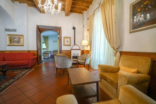 a living room with a couch and a table at HG Abetone e Piramidi Resort in Abetone