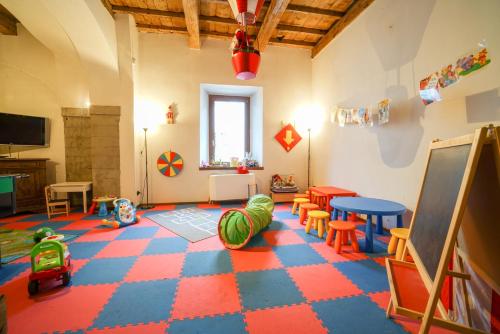 a room filled with lots of different colored tables and chairs at HG Abetone e Piramidi Resort in Abetone