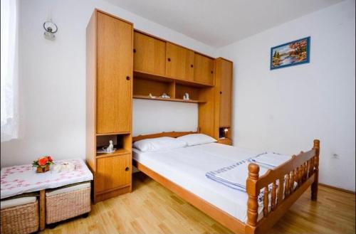 a bedroom with a large bed with wooden cabinets at Milojka in Senj