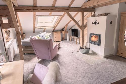 a living room with a couch and a fireplace at Gipfelkönig in Bayrischzell