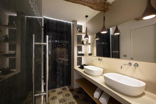 a bathroom with two sinks and a shower at Life Class Apartment in Riomaggiore