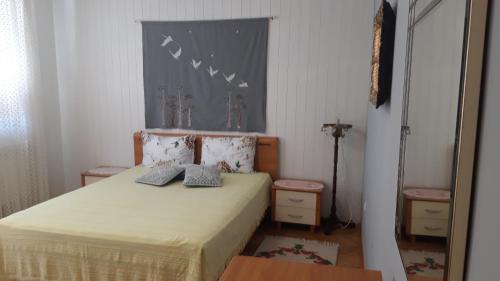 a bedroom with a bed with two pillows on it at Apartman Oasis 2 Ilidza in Sarajevo