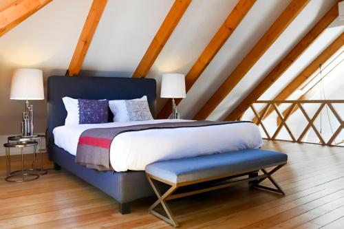 a bedroom with a king sized bed and a blue bench at Oporto Chic&Cozy - Ribeira in Porto