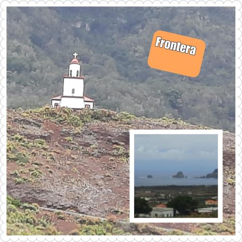 a lighthouse on top of a hill with an orange box at MI CUMANESA in Frontera