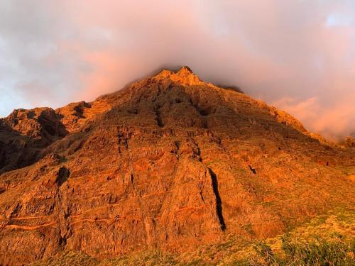 a mountain peak with a cloudy sky in the background at MI CUMANESA in Frontera