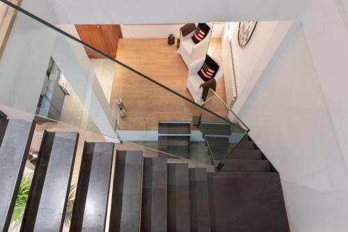 a staircase with a glass railing and a stair case at NEW! Villa Boutique Mallorca in Lloseta