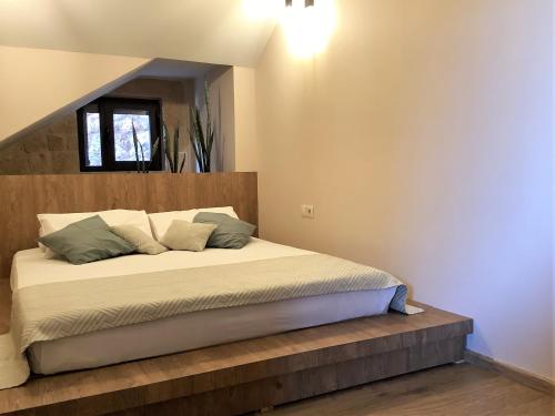 a bedroom with a bed with a wooden headboard at Archon Villa in Pandeleḯmon