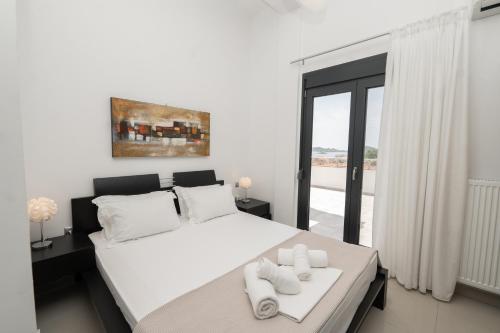 Postel nebo postele na pokoji v ubytování Aelia Apartments