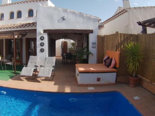 a backyard with a pool and a house at Casa Calida in Murcia