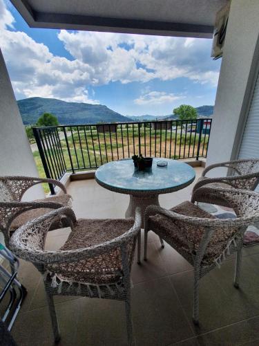 a table and chairs on a balcony with a view at Sunshine in Trebinje