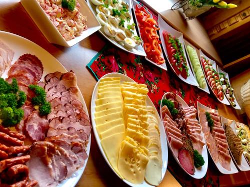 a table with plates of different types of food at Dom Wypoczynkowy Koliba in Białka Tatrzanska