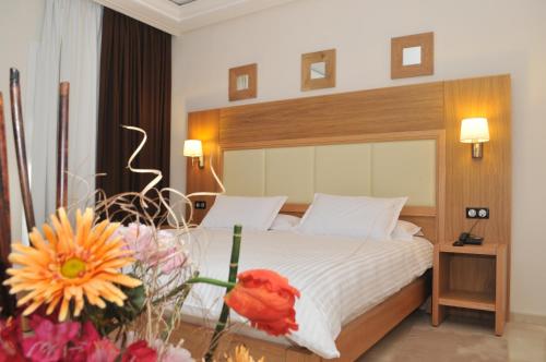 Säng eller sängar i ett rum på Hotel LA PALOMA