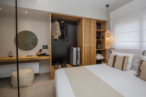 a bedroom with a large white bed and a desk at Moncasa Your Ionian home in Kouvaláta
